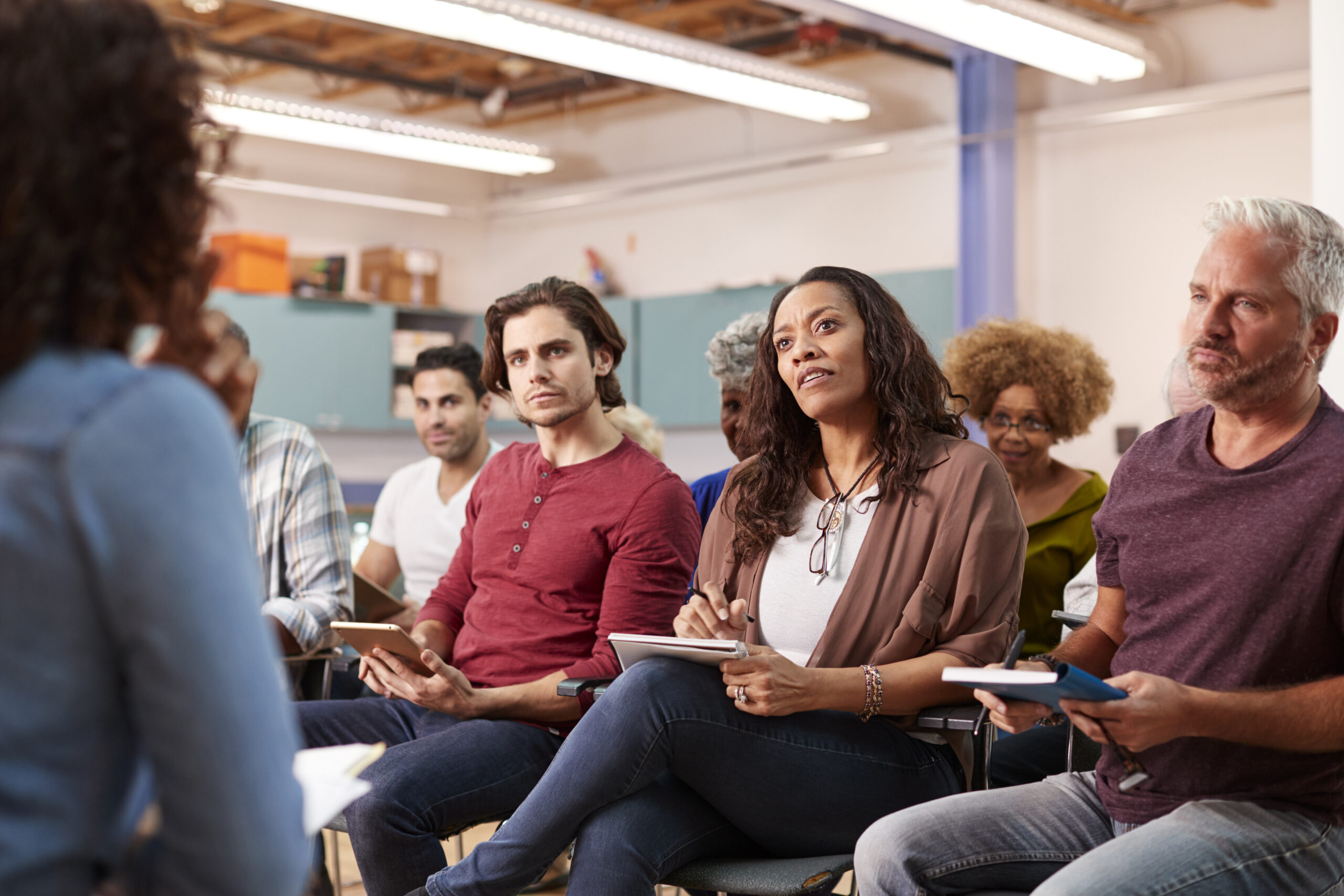 Group Making Notes Whilst Attending Neighborhood Meeting